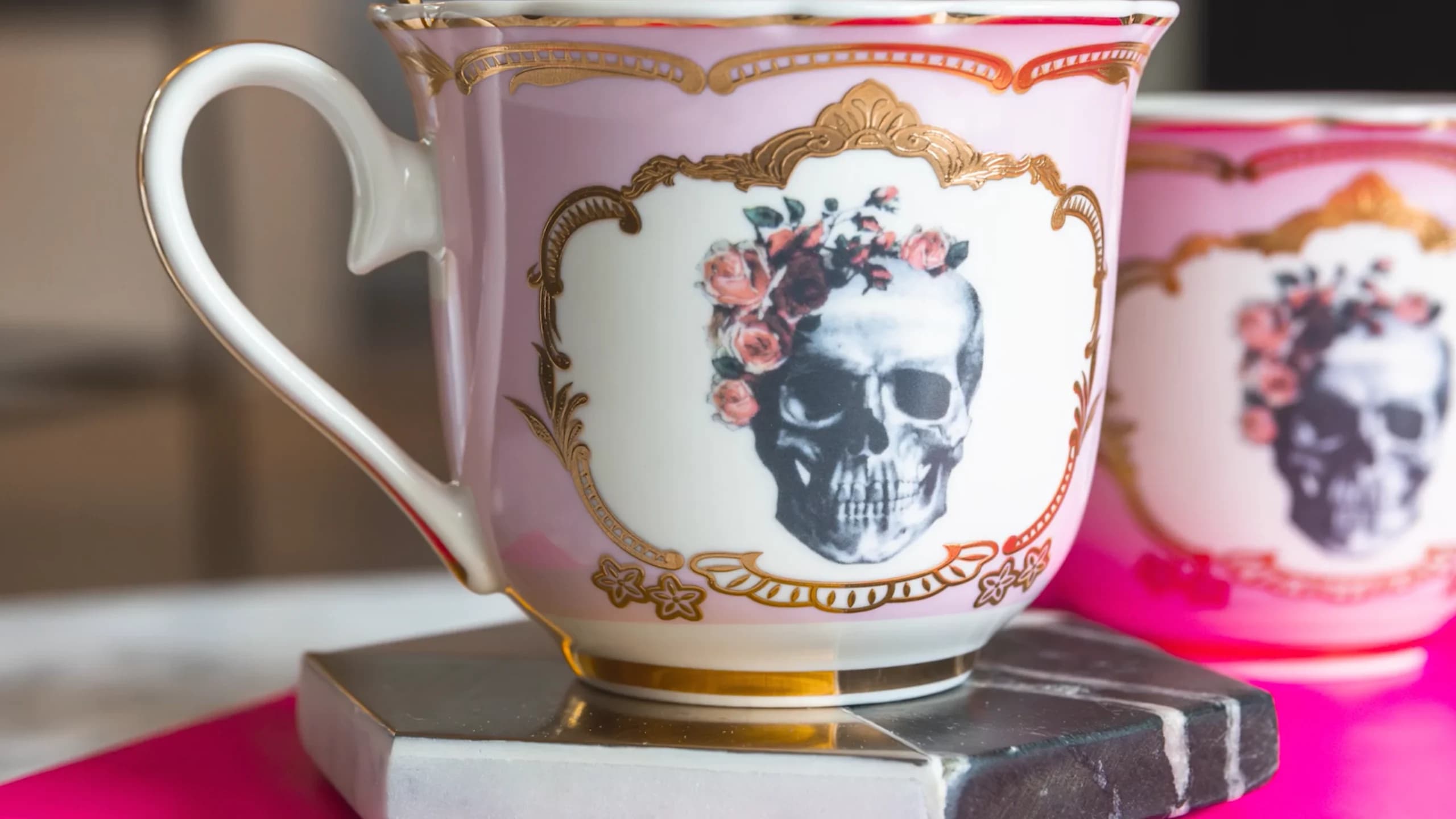 Image of tea cups with skulls adorned with flowers.